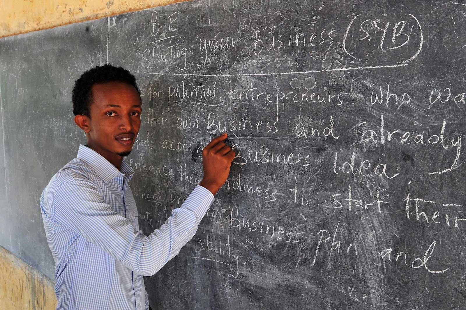 Man in front of a chalkboard